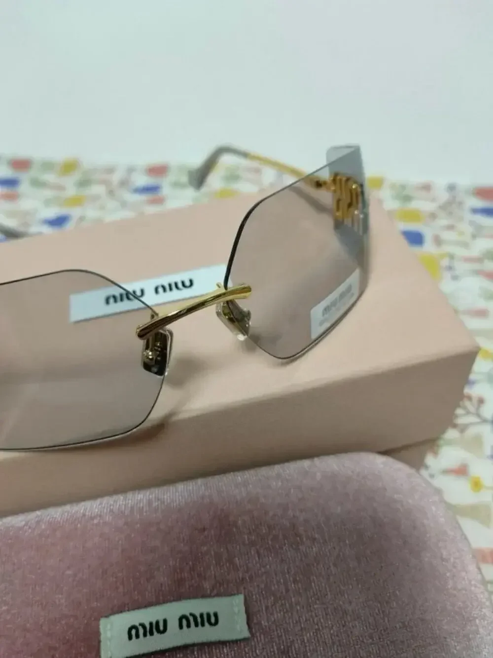 Miu Miu Rimless Grey Sunglasses with Oversized Gold Logo